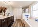 A full bathroom with a single sink vanity, tub, and shower combo with blue and white tiling at 3022 Bransbury Ct, Kissimmee, FL 34747