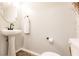 Powder room features a pedestal sink, standard toilet, and simple wall decorations at 3022 Bransbury Ct, Kissimmee, FL 34747