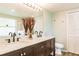 Bathroom with a double sink vanity with marble countertop, and neutral colored walls at 3022 Bransbury Ct, Kissimmee, FL 34747