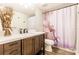 Bathroom featuring modern vanity with dark wood cabinet, mirror, and shower at 3022 Bransbury Ct, Kissimmee, FL 34747