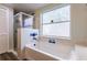 Bathroom features a bathtub and a glass enclosed shower with blue and white tiling at 3022 Bransbury Ct, Kissimmee, FL 34747