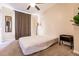 Bedroom with neutral carpet featuring a bed, mirror, floor lamp, and a green plant at 3022 Bransbury Ct, Kissimmee, FL 34747