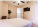 This bedroom offers a modern ceiling fan, television, and simple decor at 3022 Bransbury Ct, Kissimmee, FL 34747