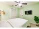Bright green bedroom with neutral carpet, featuring a ceiling fan and a wall-mounted TV at 3022 Bransbury Ct, Kissimmee, FL 34747