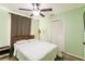 Bright green bedroom with neutral carpet featuring a fan, bed, floor lamp, and closet at 3022 Bransbury Ct, Kissimmee, FL 34747