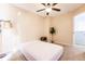 Bedroom with neutral carpet, featuring a bed, floor lamp, a green plant, and a side table at 3022 Bransbury Ct, Kissimmee, FL 34747