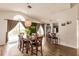 Open-concept dining room with a wooden table, barstool seating, and a bright, airy ambiance at 3022 Bransbury Ct, Kissimmee, FL 34747