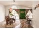 Elegant dining room with a rustic table, stylish chairs, and a unique green wall feature at 3022 Bransbury Ct, Kissimmee, FL 34747