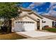 Well-maintained single-Gathering home with a two-car garage, green lawn, and classic curb appeal at 3022 Bransbury Ct, Kissimmee, FL 34747