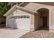 Attached two-car garage with decorative windows and a paved walkway leading to the front door at 3022 Bransbury Ct, Kissimmee, FL 34747