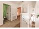 Bright hallway area with a dining space, featuring a stair rail and several doorways at 3022 Bransbury Ct, Kissimmee, FL 34747