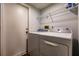 Well-lit laundry room with modern washer and dryer, and storage shelving at 3022 Bransbury Ct, Kissimmee, FL 34747