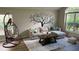 Living room featuring a sectional sofa and a large tree wall decal at 3022 Bransbury Ct, Kissimmee, FL 34747