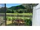 Wooden picnic table with green umbrella overlooking a pond at 3022 Bransbury Ct, Kissimmee, FL 34747