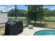 Pool area with grill, lounge chair, and fenced yard at 3022 Bransbury Ct, Kissimmee, FL 34747