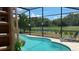 Inviting pool with screened enclosure and backyard view at 3022 Bransbury Ct, Kissimmee, FL 34747