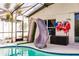 Poolside view featuring an attached slide, safety life vests, and outdoor seating at 3022 Bransbury Ct, Kissimmee, FL 34747