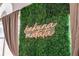 Close up on a wall decorated with artificial greenery and a neon 'Hakuna Matata' sign at 3022 Bransbury Ct, Kissimmee, FL 34747