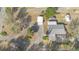 Aerial view of a house with a large backyard, a circular driveway, and sheds at 30844 Buttercup Ln, Mount Dora, FL 32757