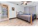 Cozy bedroom with wood-look floors and ceiling fan at 30844 Buttercup Ln, Mount Dora, FL 32757