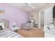 Twin bedroom with lilac wall and two beds at 3152 Yellow Lantana Ln, Kissimmee, FL 34747