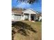 One-story home with gray exterior, double doors, and a well-manicured lawn at 3603 Kariba Ct, Kissimmee, FL 34746