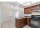 Kitchen with breakfast bar and dark wood cabinets at 4392 S Lake Orlando Pkwy # 4, Orlando, FL 32808