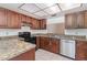 Kitchen with dark wood cabinets, granite counters, and appliances at 4392 S Lake Orlando Pkwy # 4, Orlando, FL 32808
