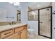 Bright bathroom features a large vanity and glass enclosed shower at 5810 Penney Ln, The Villages, FL 32163