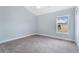 An empty bedroom with carpet and a large window at 5810 Penney Ln, The Villages, FL 32163
