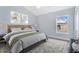 A staged bedroom featuring carpet, light colored walls, and a large window at 5810 Penney Ln, The Villages, FL 32163