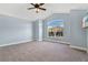An empty room with a vaulted ceiling, carpet and a large window at 5810 Penney Ln, The Villages, FL 32163
