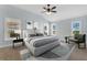 This bedroom features a ceiling fan, neutral color palette, carpet, and a decorative area rug at 5810 Penney Ln, The Villages, FL 32163