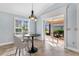 Dining area with a table, chairs, and a view of the outdoor patio at 5810 Penney Ln, The Villages, FL 32163