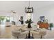 Open-concept living area with modern furniture, stylish decor, and tiled floors at 5810 Penney Ln, The Villages, FL 32163
