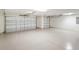 Spacious three-car garage featuring a clean epoxy floor and ample room for vehicles and storage at 5810 Penney Ln, The Villages, FL 32163