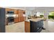 Well-appointed kitchen with granite countertops, stainless appliances, and breakfast bar at 5810 Penney Ln, The Villages, FL 32163