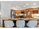 Modern kitchen with granite countertops, stainless steel appliances, and bar seating at 5810 Penney Ln, The Villages, FL 32163