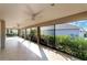 Large screened-in lanai offering outdoor living space with ceiling fans and views of the backyard and greenery at 5810 Penney Ln, The Villages, FL 32163