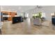 Spacious living room open to the kitchen with a breakfast bar and access to the outdoors at 5810 Penney Ln, The Villages, FL 32163