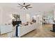 Bright living room with modern decor and open layout to the kitchen and dining areas at 5810 Penney Ln, The Villages, FL 32163