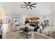 Open-concept living area with dining and kitchen views, tile floors, and stylish furnishings at 5810 Penney Ln, The Villages, FL 32163