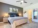 Main bedroom with dark accent wall, cozy bedding, and ensuite bath access at 605 Tortuga Ct, New Smyrna Beach, FL 32168