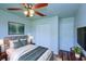 Well lit bedroom features a ceiling fan, wood look floors, and ample closet space for storage at 637 Twin Lake Ave, Deltona, FL 32738