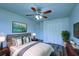 Cozy bedroom featuring a ceiling fan, closet, modern decor, and calming color palette at 637 Twin Lake Ave, Deltona, FL 32738