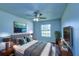 A staged bedroom with a bed, window, and matching nightstands and dresser at 637 Twin Lake Ave, Deltona, FL 32738