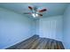 Bedroom with wood-look floors, ceiling fan, and closet at 637 Twin Lake Ave, Deltona, FL 32738