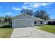 House exterior featuring gray siding and a two-car garage at 637 Twin Lake Ave, Deltona, FL 32738