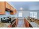 Modern kitchen with granite countertops, stainless steel appliances, and wood cabinets at 637 Twin Lake Ave, Deltona, FL 32738