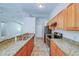 Modern kitchen with granite countertops, stainless steel appliances, and wood cabinets at 637 Twin Lake Ave, Deltona, FL 32738